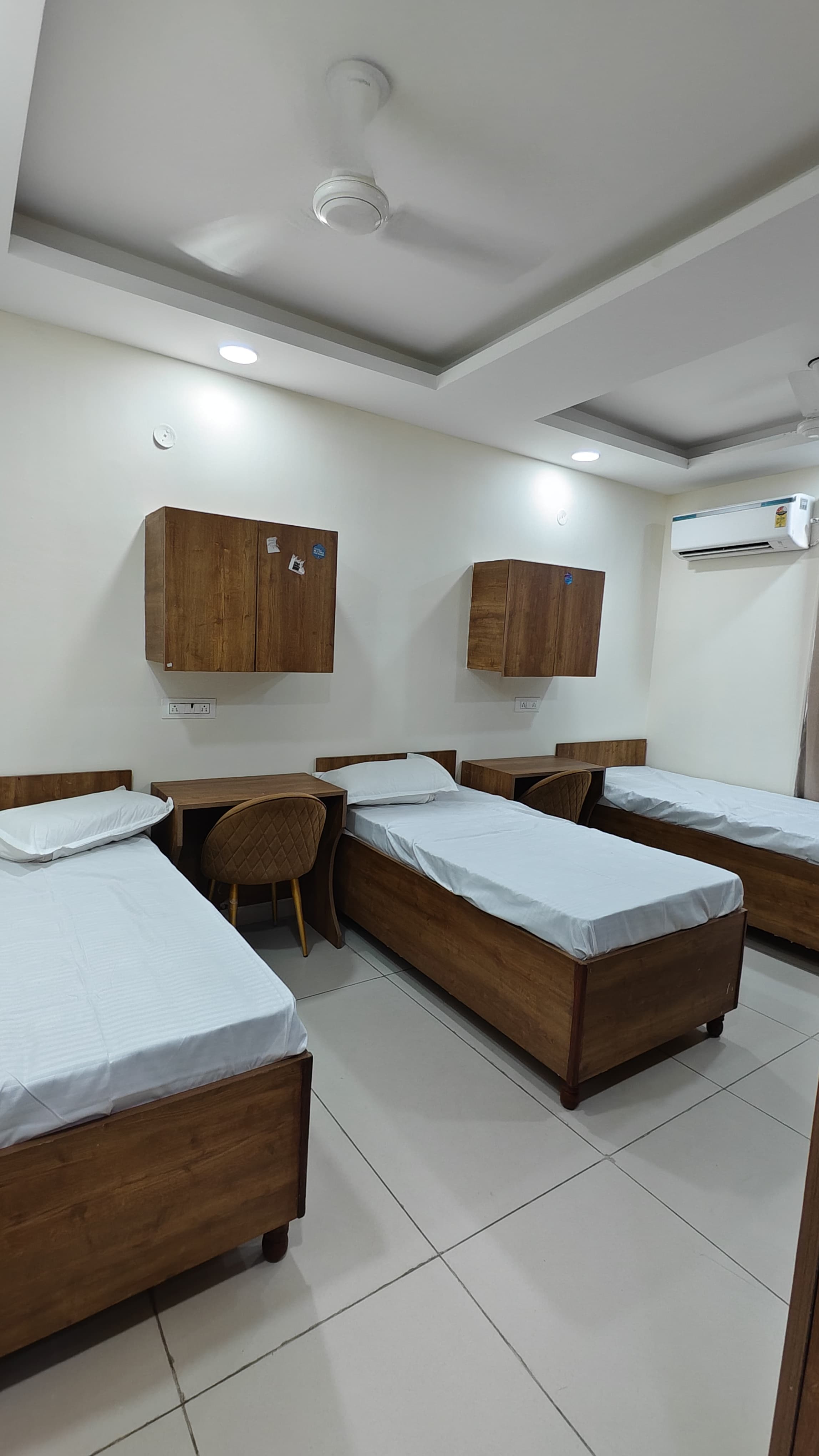 Triple sharing room with three beds and air conditioning